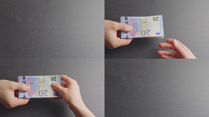 交出20欧元钞票，双手换钱的概念图。