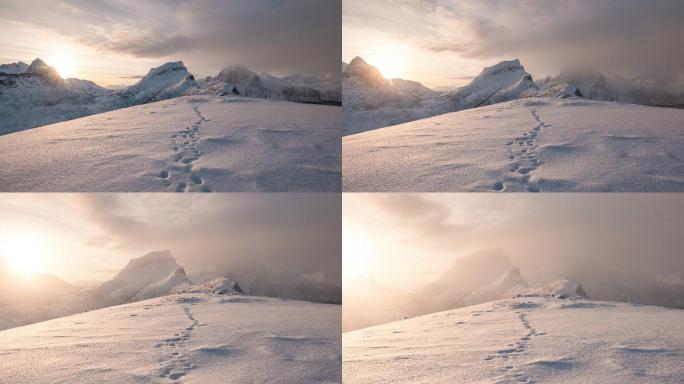 雪山山脉的时间推移与日出时雪地上的脚印