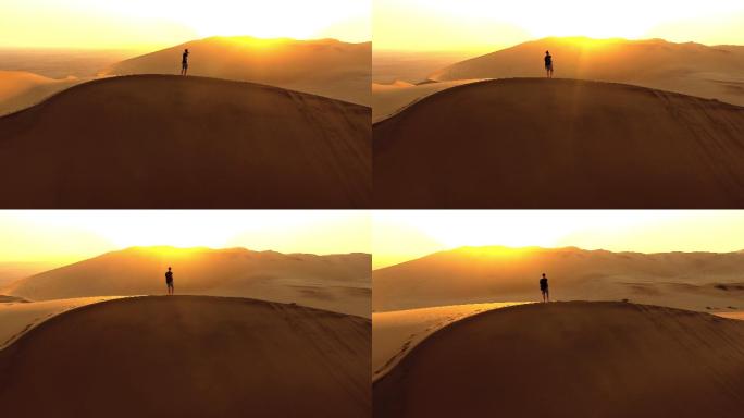沙漠中一名孤独男子在沙丘站立的画面