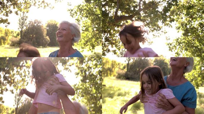 一个女人把她的孙女抛向空中，然后抓住她
