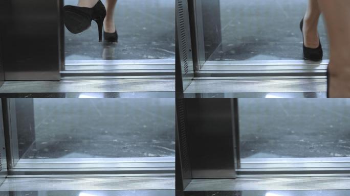 商务女士用脚挡住电梯门，进入电梯