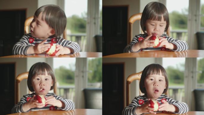 在吃苹果的小女孩幼儿小孩子开心天真笑容