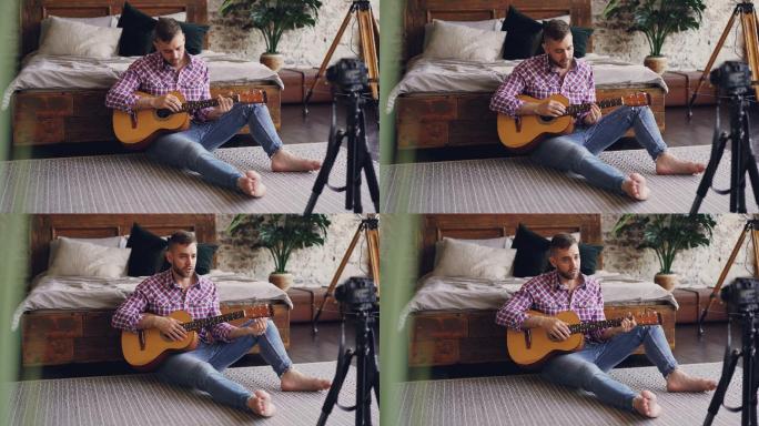 男人在家录制吉他教学视频