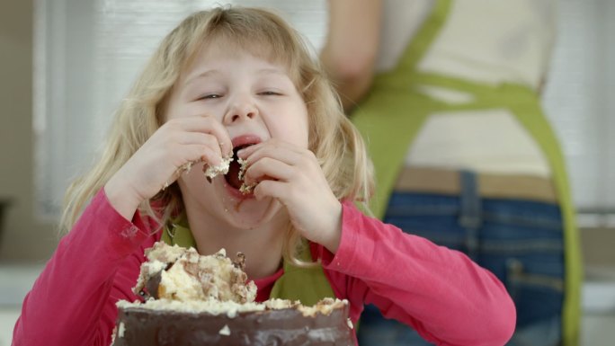 小女孩正在吞食蛋糕