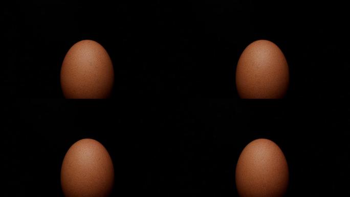 鸡蛋在黑色背景上旋转
