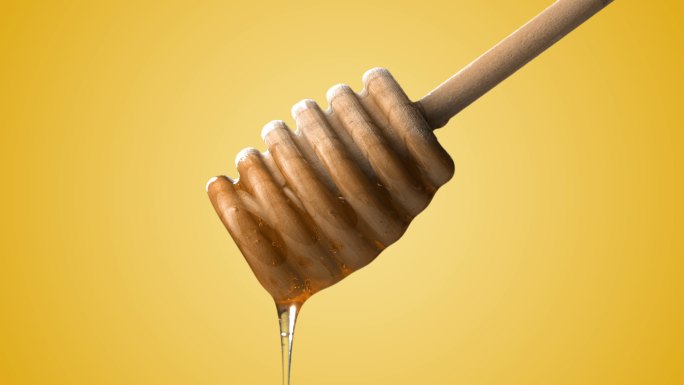 金色背景上蜂蜜棒上滴下的蜂蜜。