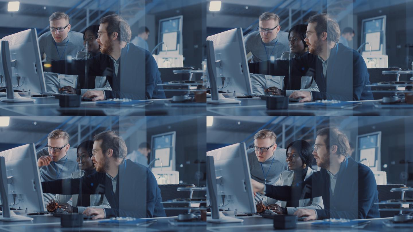 两名电子开发工程师在电脑上工作与项目经理交谈。