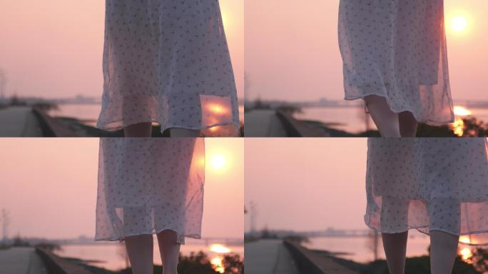 女孩在夕阳西行走时飘扬的裙角