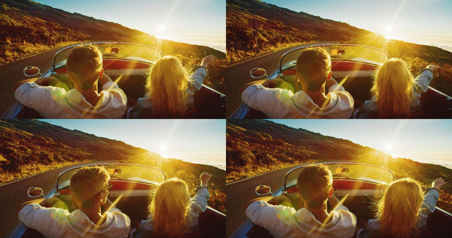 一对夫妇开车欣赏夕阳