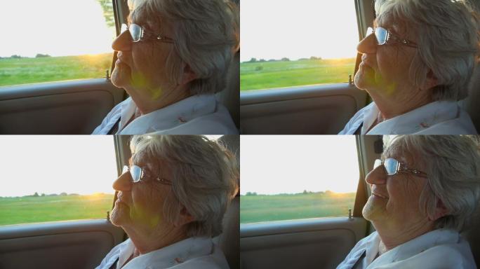 夕阳下，车里的老妇女在微笑
