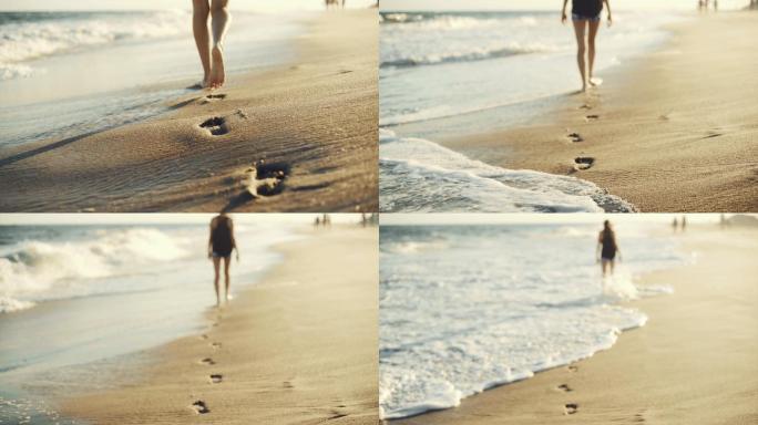 女孩走在沙滩上留下脚印