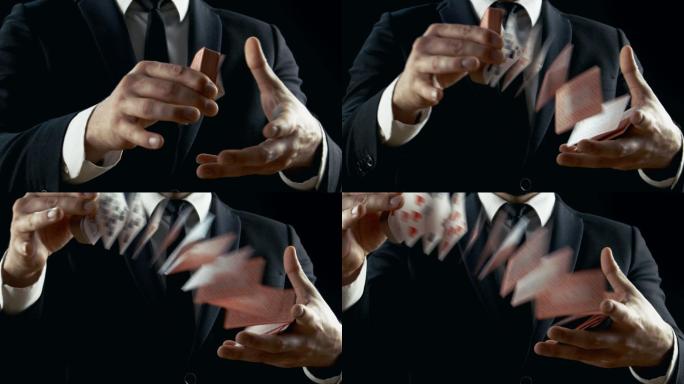 一魔术师表演纸牌戏法。
