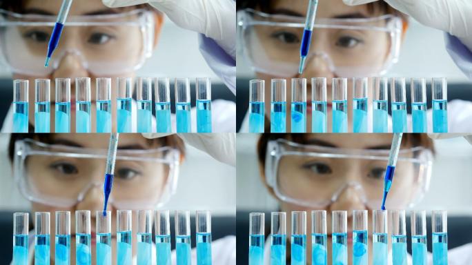 科学家用移液管分析试管中的有色液体。