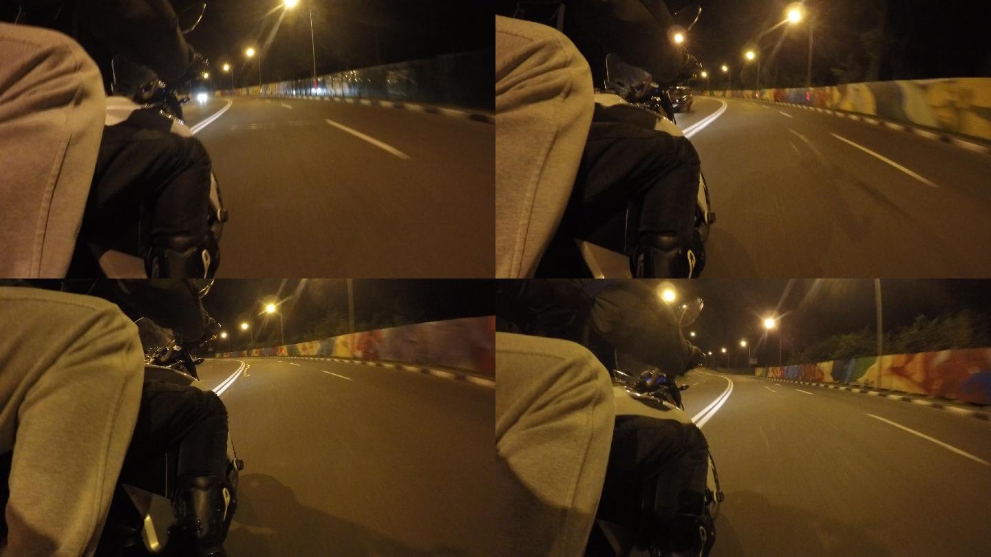 两名男子骑着摩托车行驶在傍晚的道路上