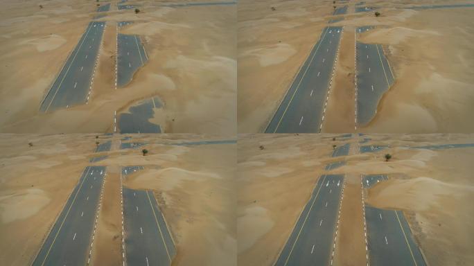 阿布扎比沙漠中被沙子覆盖的道路鸟瞰图。