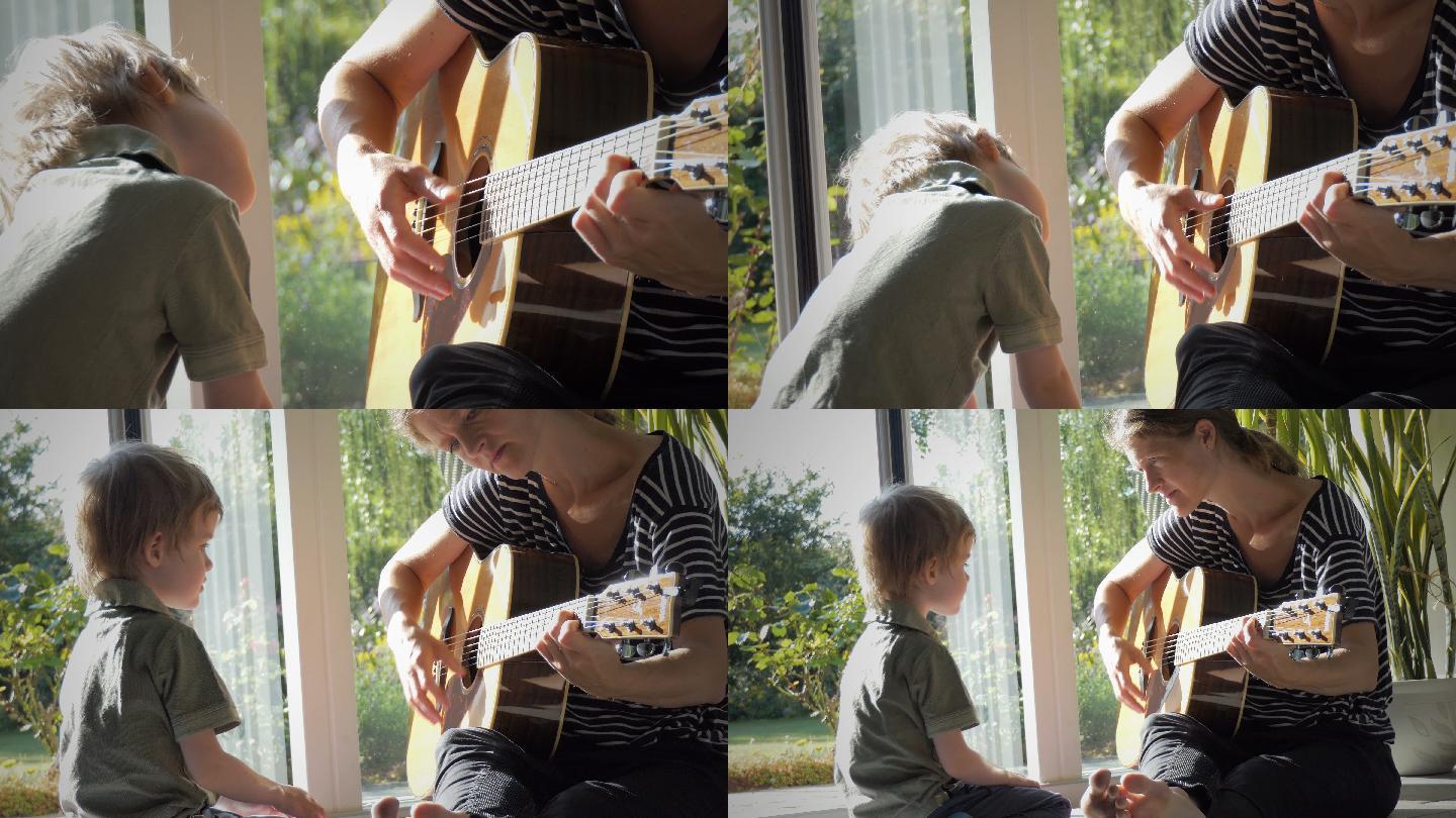 小孩喜欢听妈妈为他弹吉他。