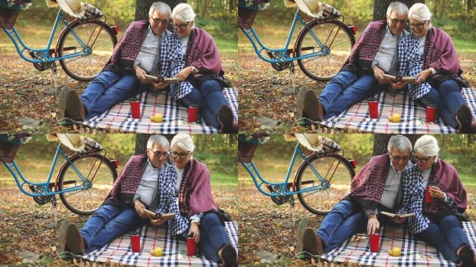可爱的老年夫妇在公园休息，看书