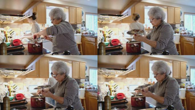 祖母正在炉子上检查她煮的汤