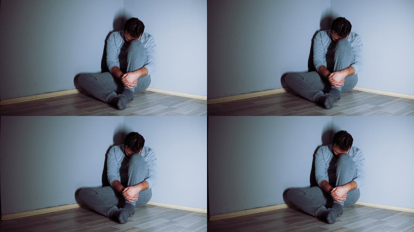 年轻的抑郁症患者独自坐在角落里。