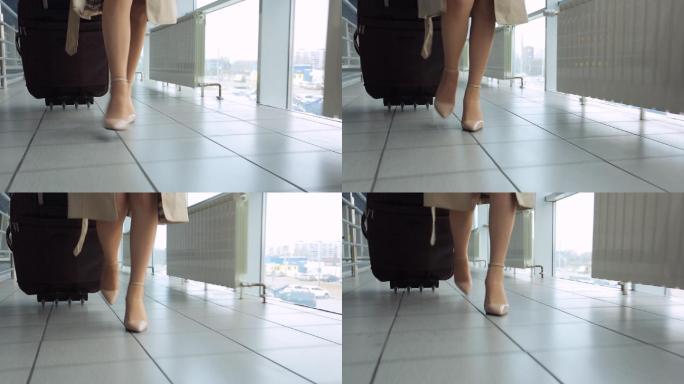 穿着高跟鞋的女人拖着行李箱
