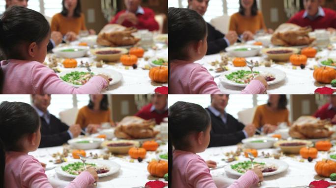 正在享受家庭感恩节晚餐的年轻女孩