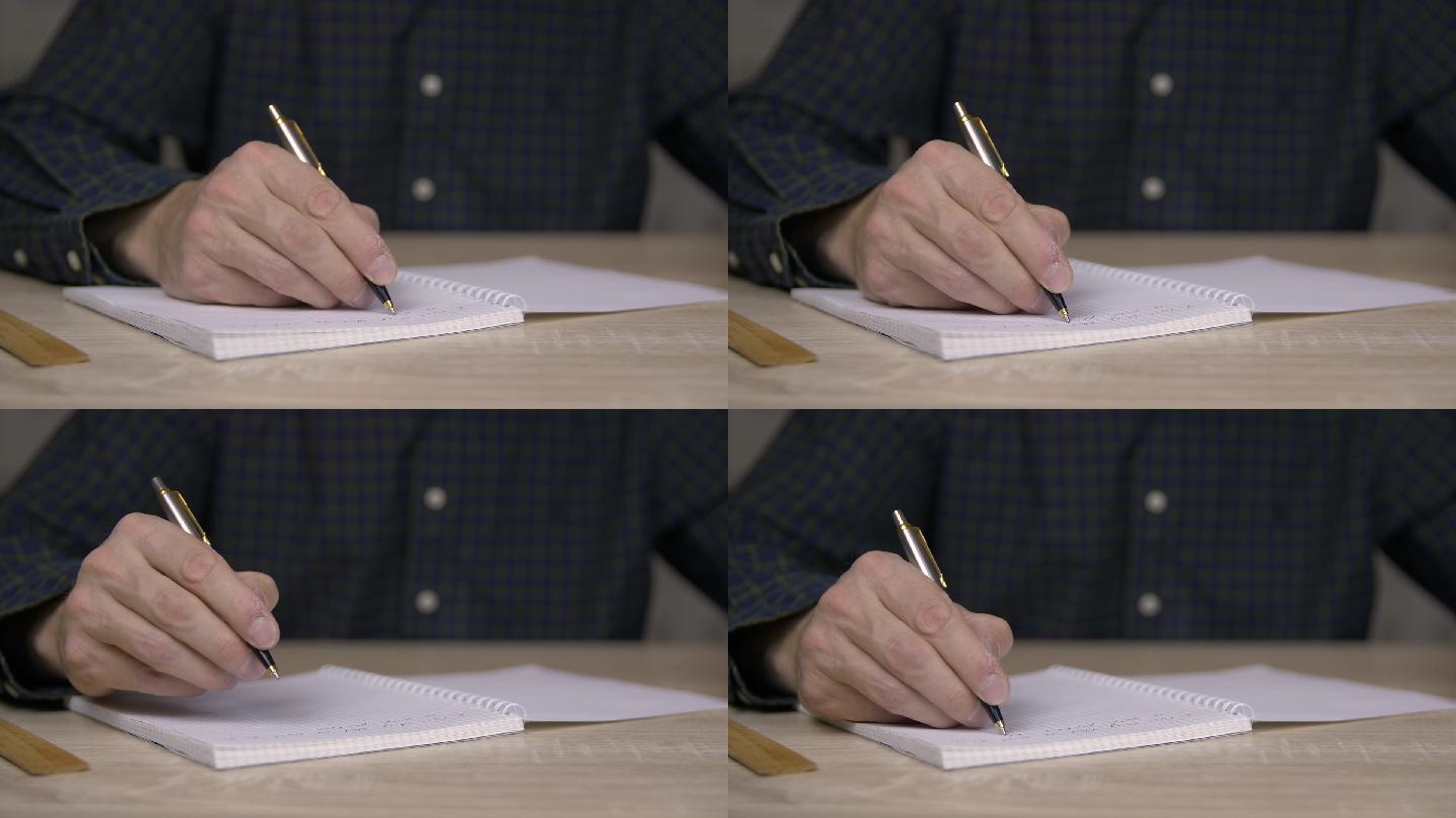 男人用笔在本子上写东西