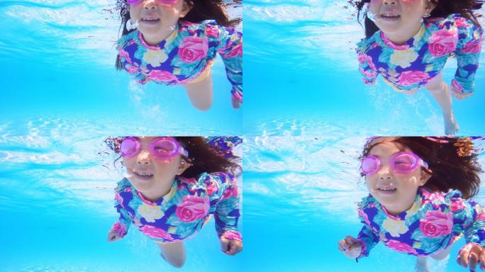 小女孩在蓝色的池水里游泳