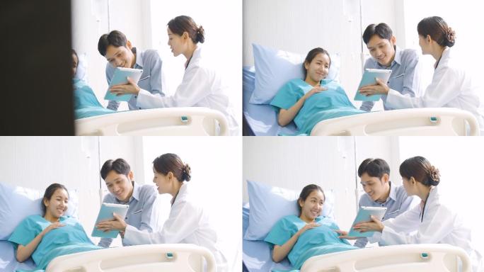夫妇兴奋地看着病房里数字平板电脑上的超声波照片。