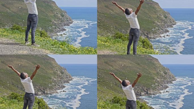 男子举起双臂看着大海的视频