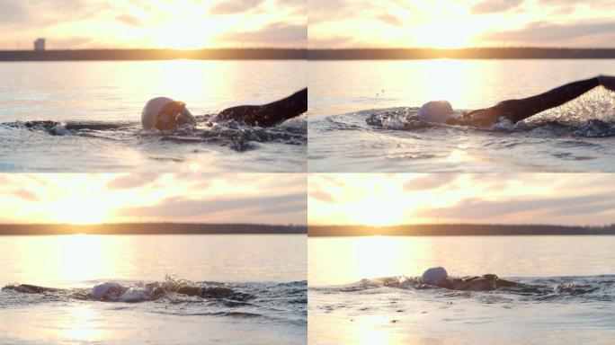 职业运动员在日落时游泳