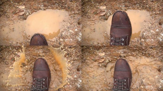 棕色皮靴踩在雨水坑，溅起水花