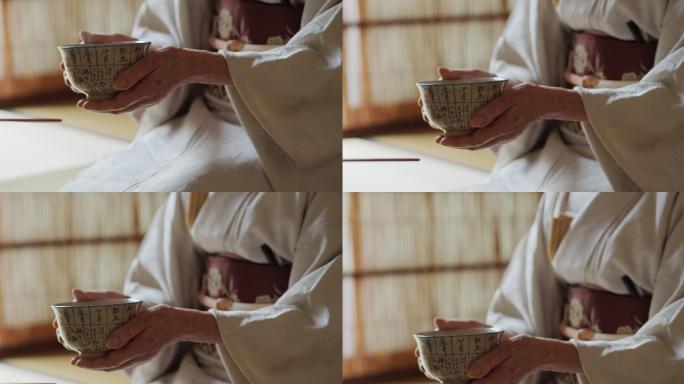 日本茶道主持人手中的一碗热气腾腾的茶
