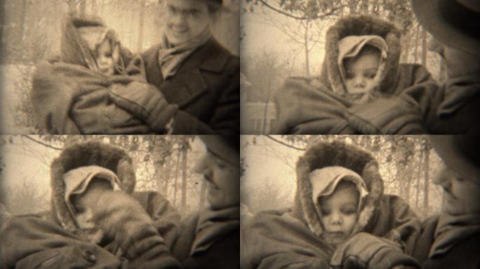 1937年：爸爸在寒冷的冬天把宝宝裹起来保暖。