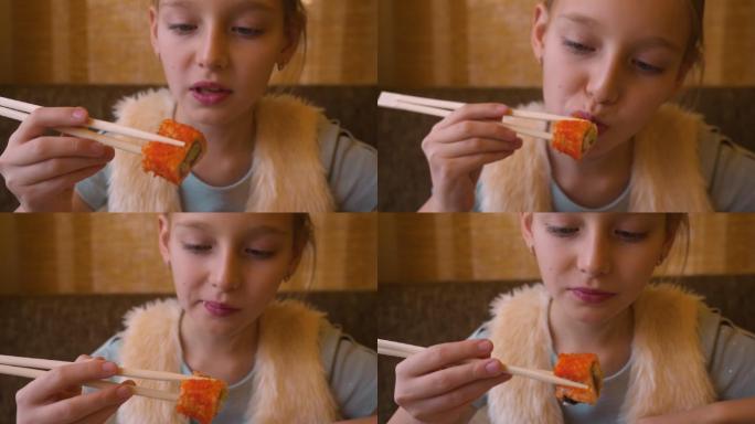 女孩在餐厅使用筷子吃寿司