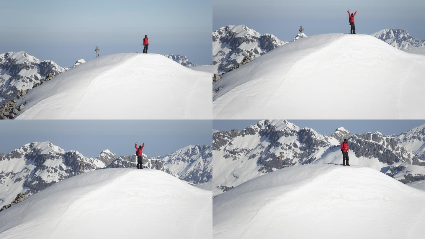 登山者在白雪覆盖的山峰上欣喜若狂