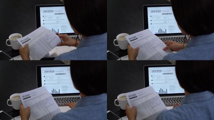 一个女人在用笔记本电脑屏幕查看银行对账单