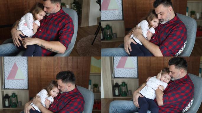 父亲和女儿坐在摇椅上拥抱