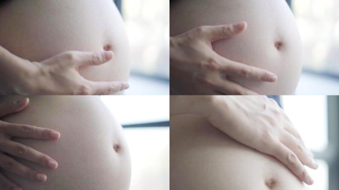 孕妇抚摸肚子特写镜头