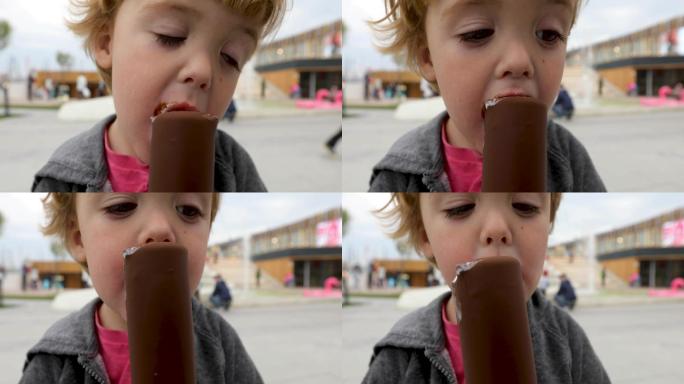 男孩吃融化的巧克力冰淇淋