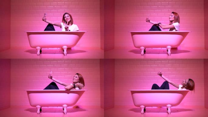 在粉色浴缸里自拍的女人