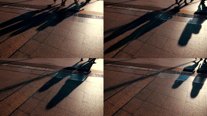 慢镜头：城市中来往行人的剪影。