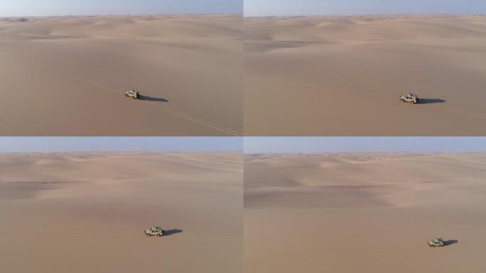 沙丘上行驶的车辆的4K平移鸟瞰图