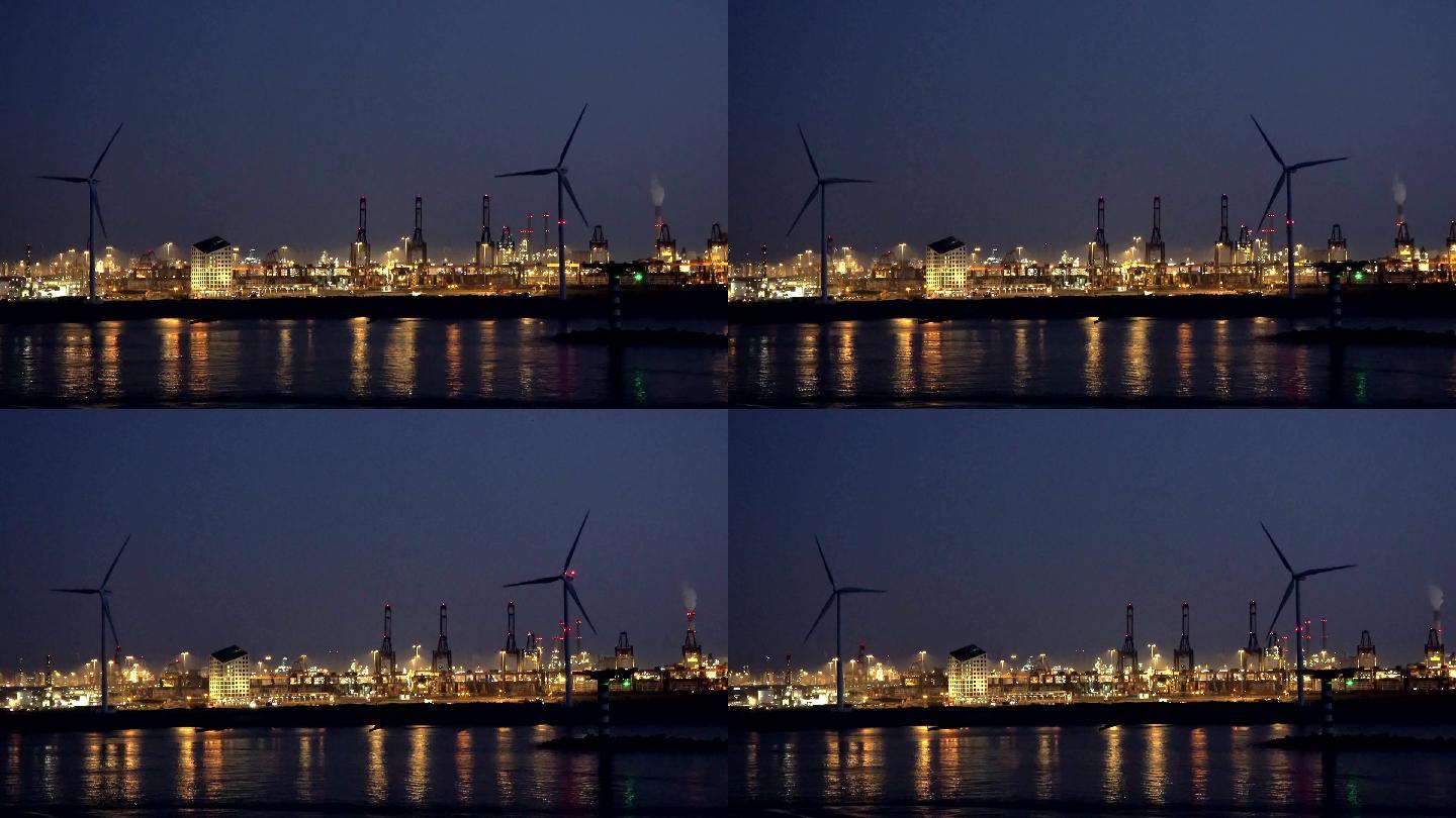 日落后的鹿特丹港国外夜景风车旋转万家灯火