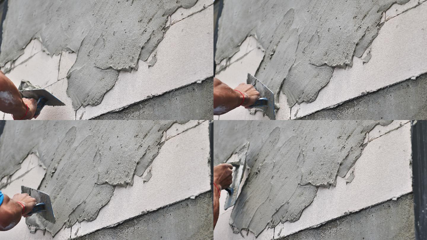 建筑工人把建筑胶涂在墙上。