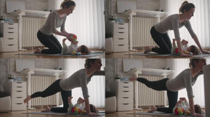 妈妈在家带着宝宝锻炼。