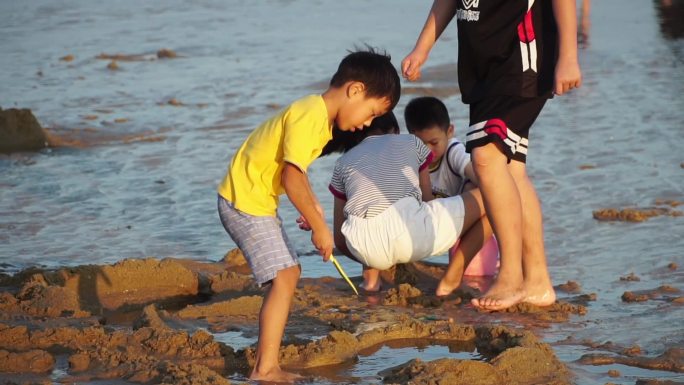儿童在海边玩沙