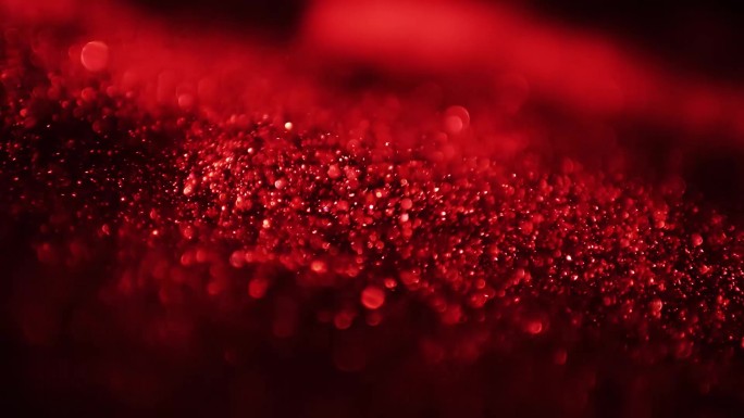 红色粒子颗粒光斑流动抽象背景