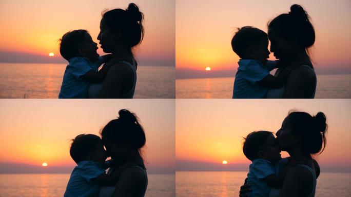 夕阳下，母亲抱着孩子亲吻