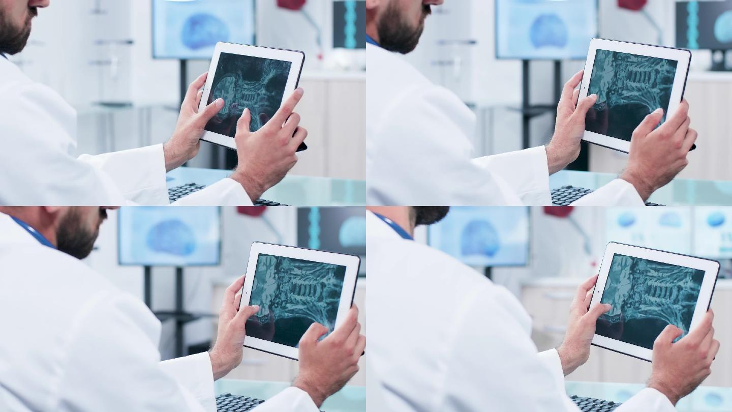 医生在平板电脑屏幕上分析 X光照片