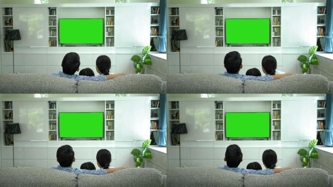 用绿色屏幕显示器观看电视的家庭